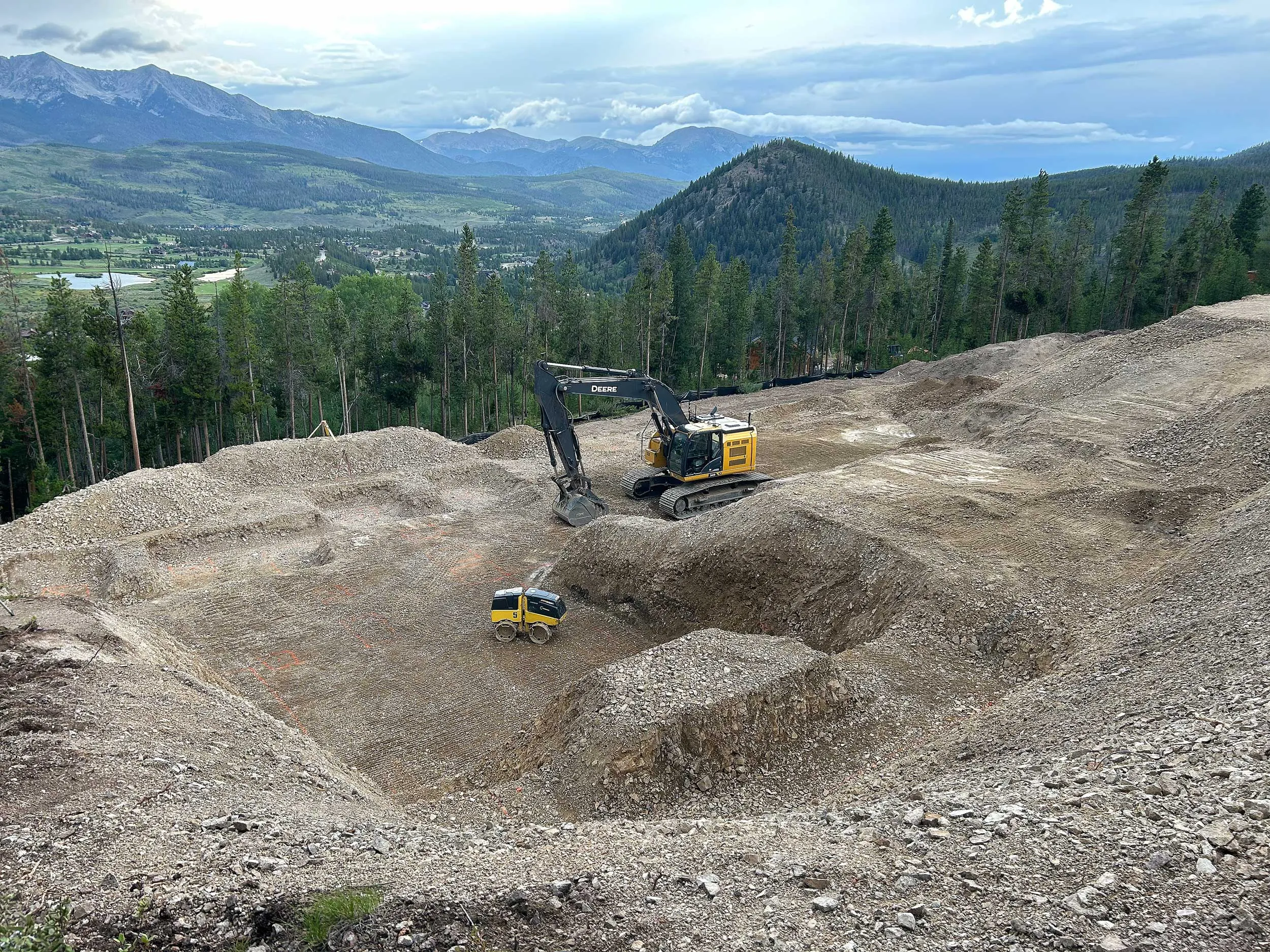 Excavator Grading Mountain Pad