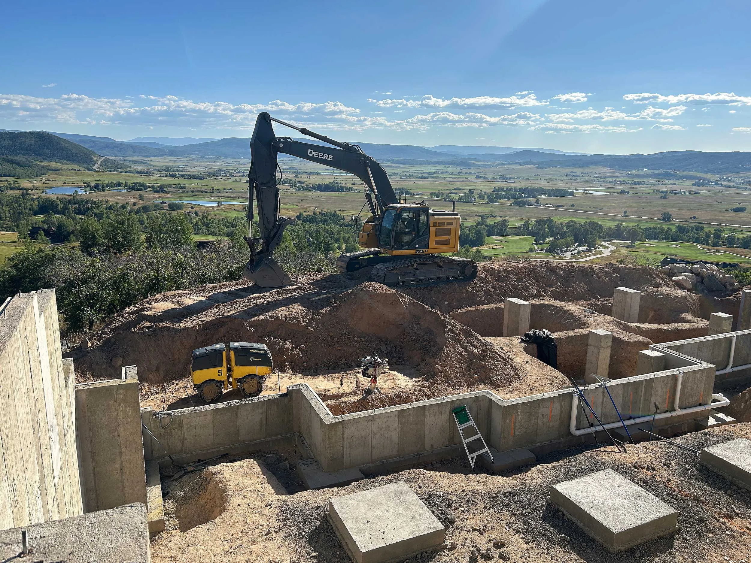 Excavator Over Foundation Walls