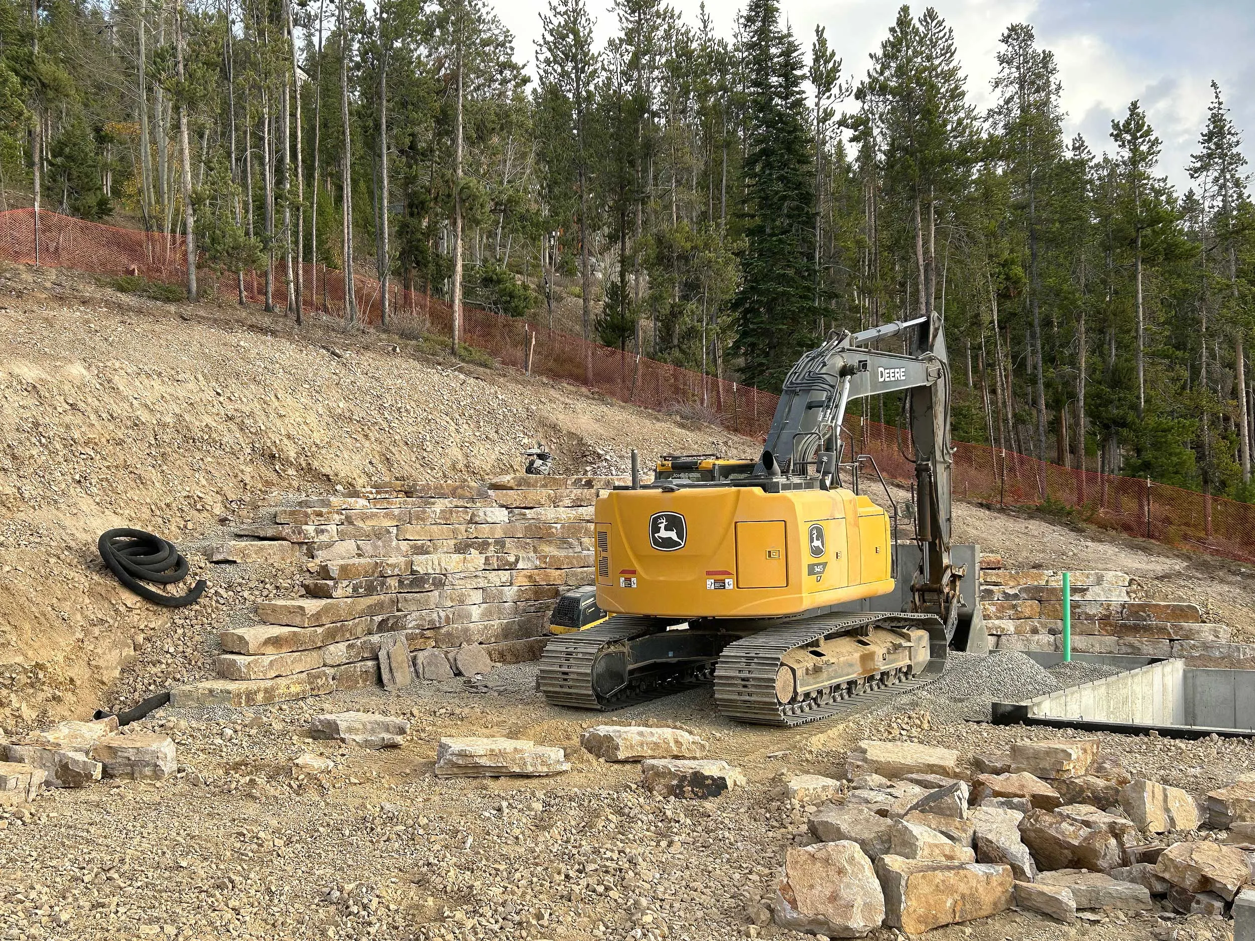 Excavator Building Tiered Wall