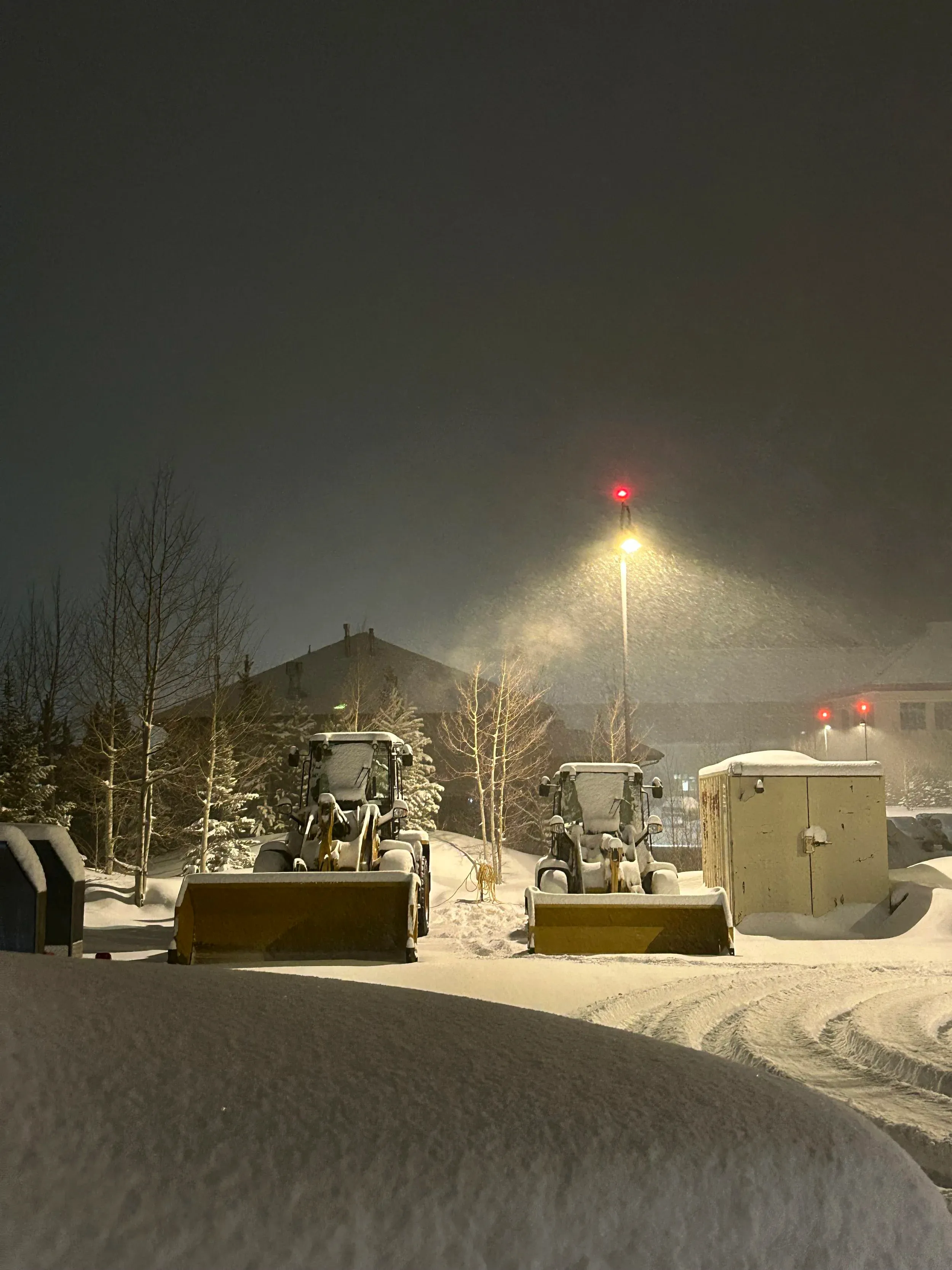 Alpine Snowworks equipment clearing snow at night